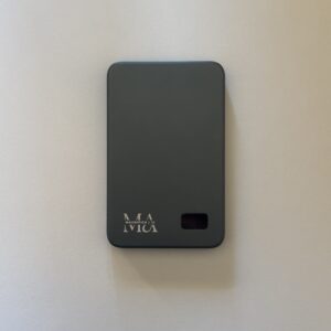 Sleek gray Magnifica powerbank with engraved logo on a neutral background.